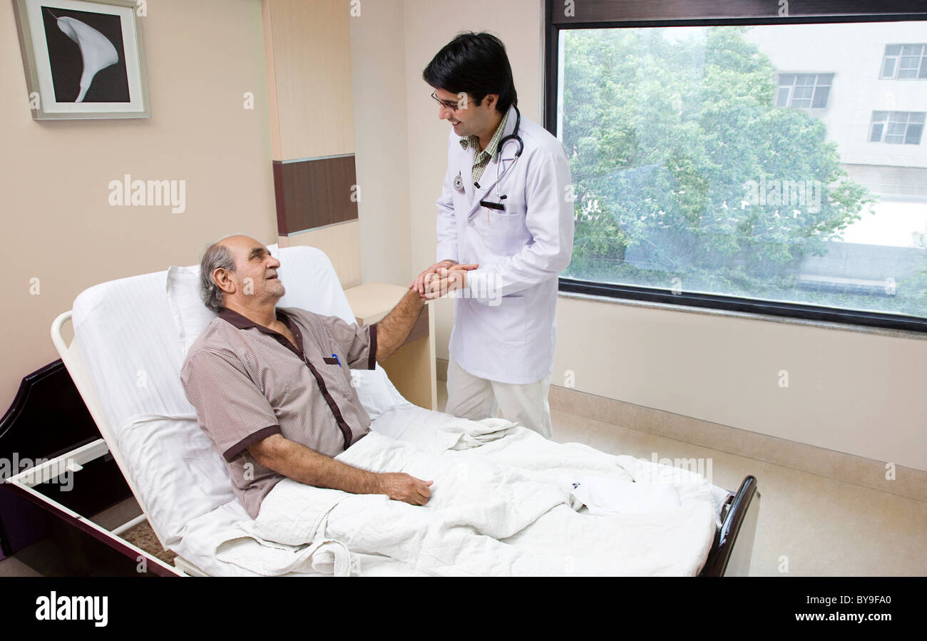 Doctor holding his patient's hand Stock Photo