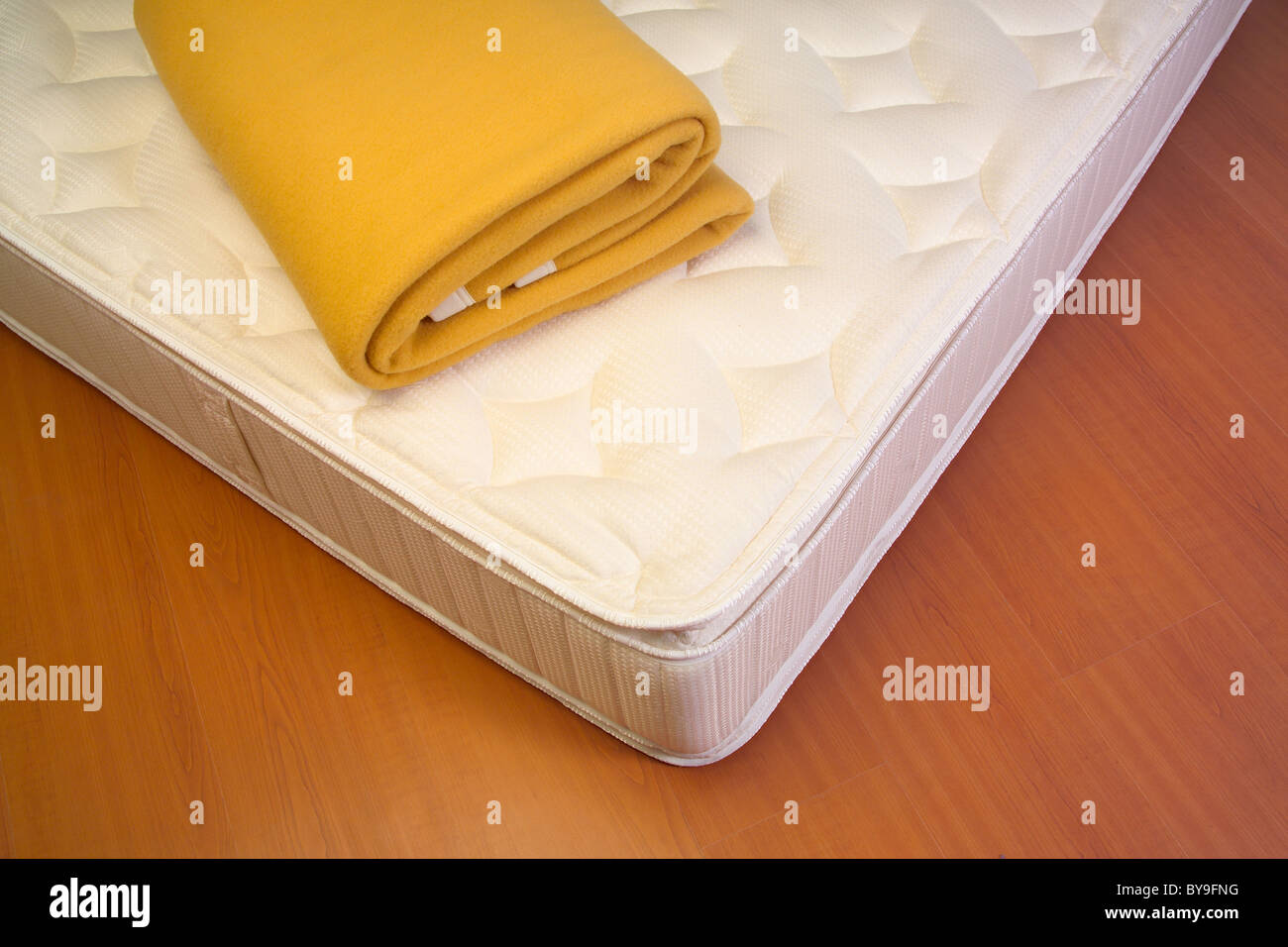 Mattress and yellow blanket Stock Photo Alamy