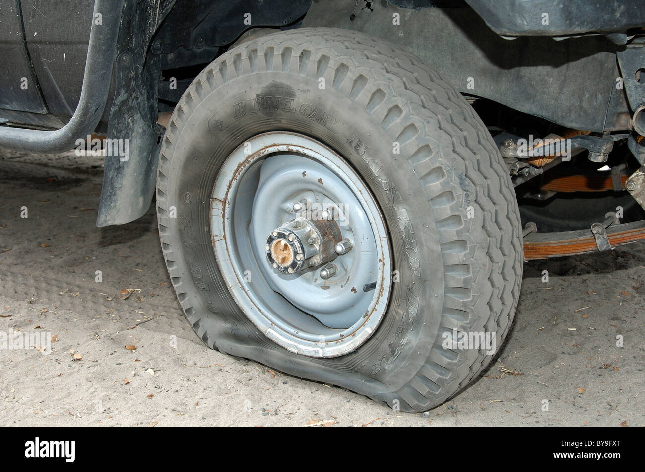 Flat Dunlop tyre on a jeep, Moremi Nature Reserve, Botswana, Africa Stock Photo