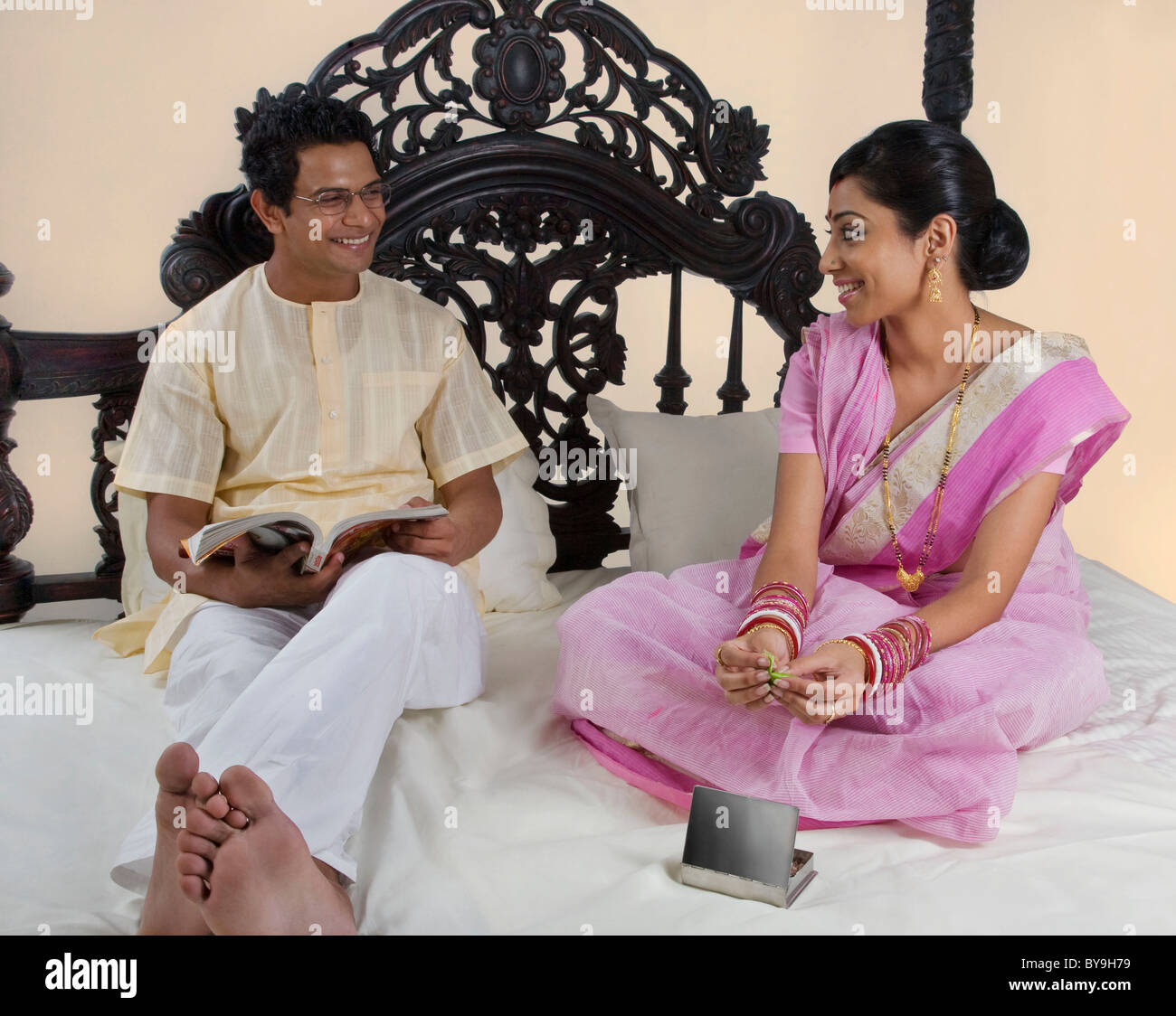Bengali couple relaxing on a bed Stock Photo Alamy