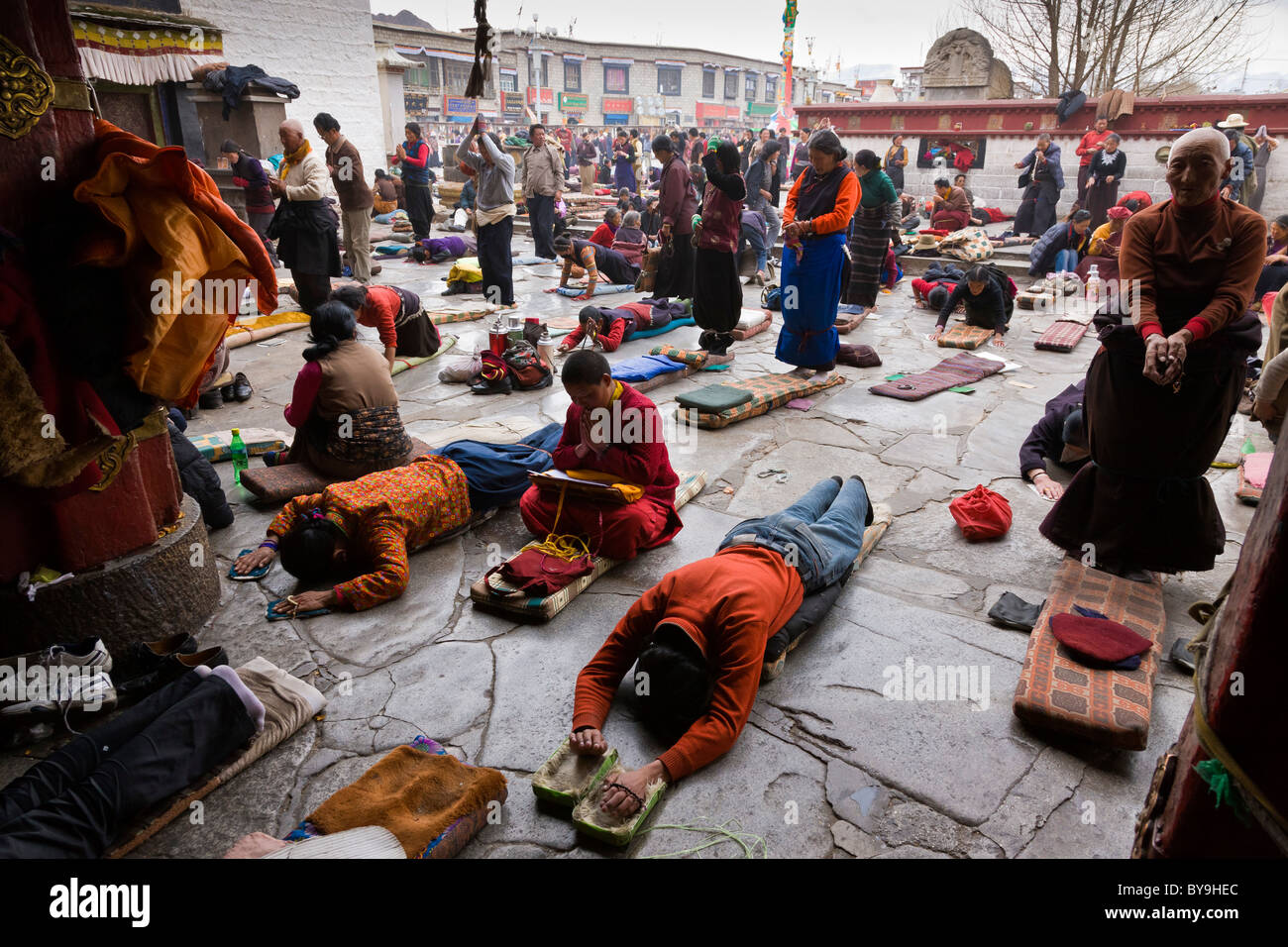 Pilgrims prostrating themselves outside the entrance to the Jokhang ...