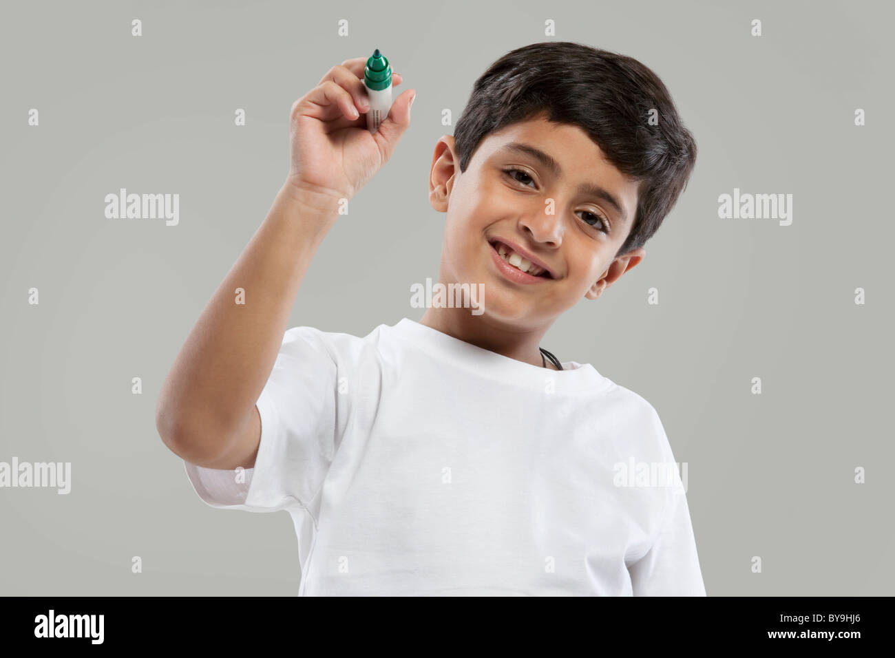 Young boy holding a marker pen Stock Photo