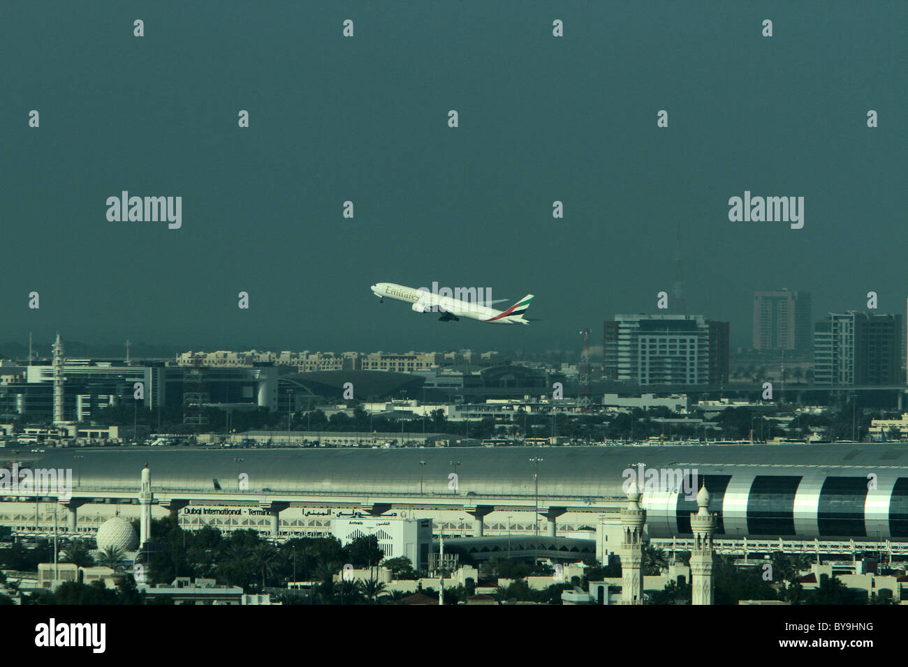 A plane takes off from Dubai's new International Airport terminal Stock Photo
