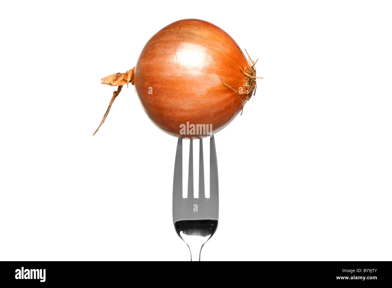 Photo of a brown onion on a fork isolated on a white background, part of a series. Stock Photo