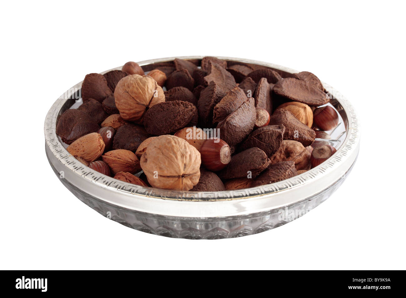 A Bowl of mixed nuts in shells on white background Stock Photo