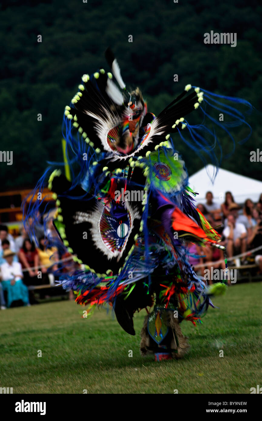 A Native American performs in a double bustle costume at the Cherokee