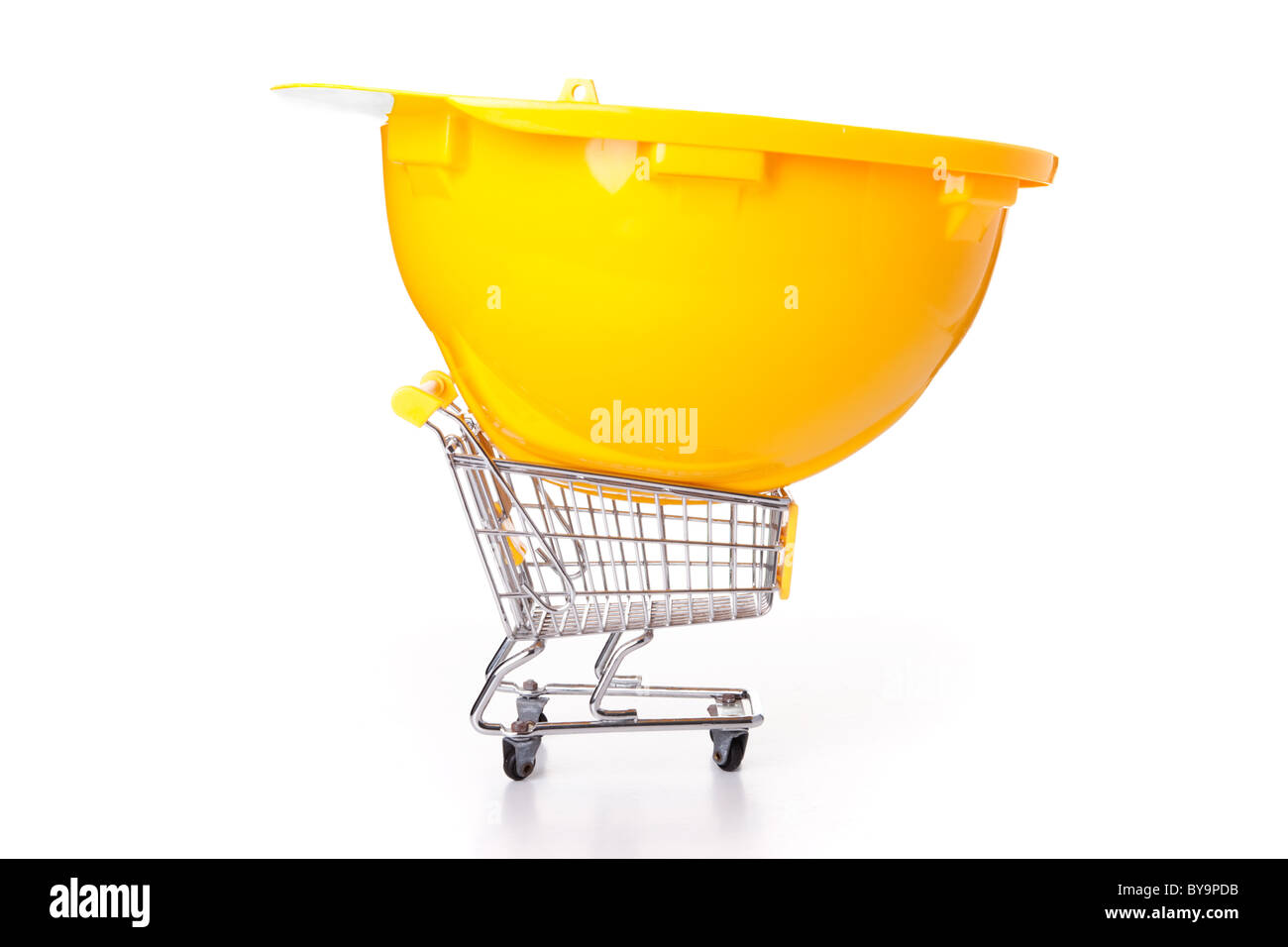 construction helmet over a shopping cart (isolated on white) Stock Photo