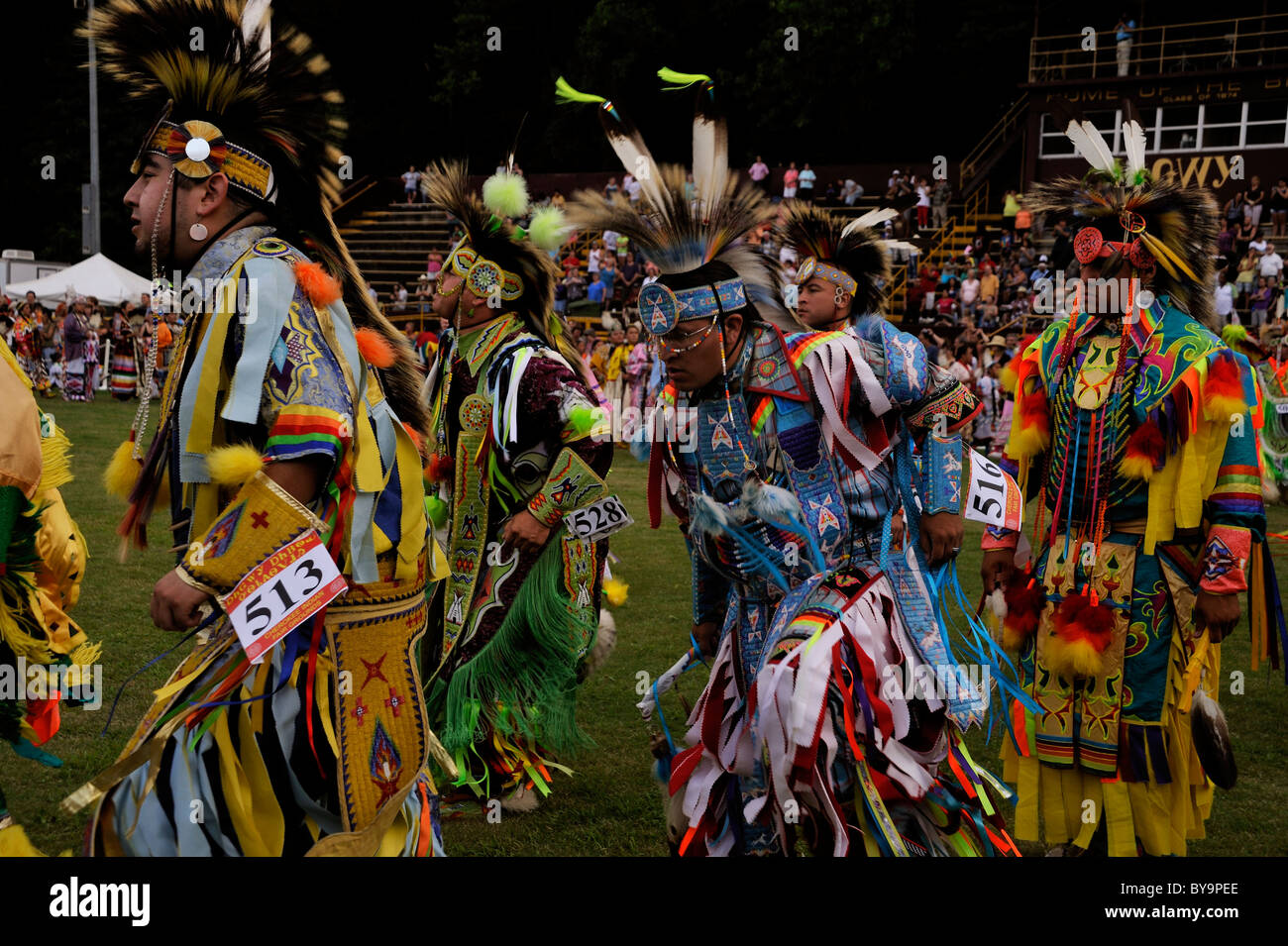 Native American dancers parade together in the grand entrance to the