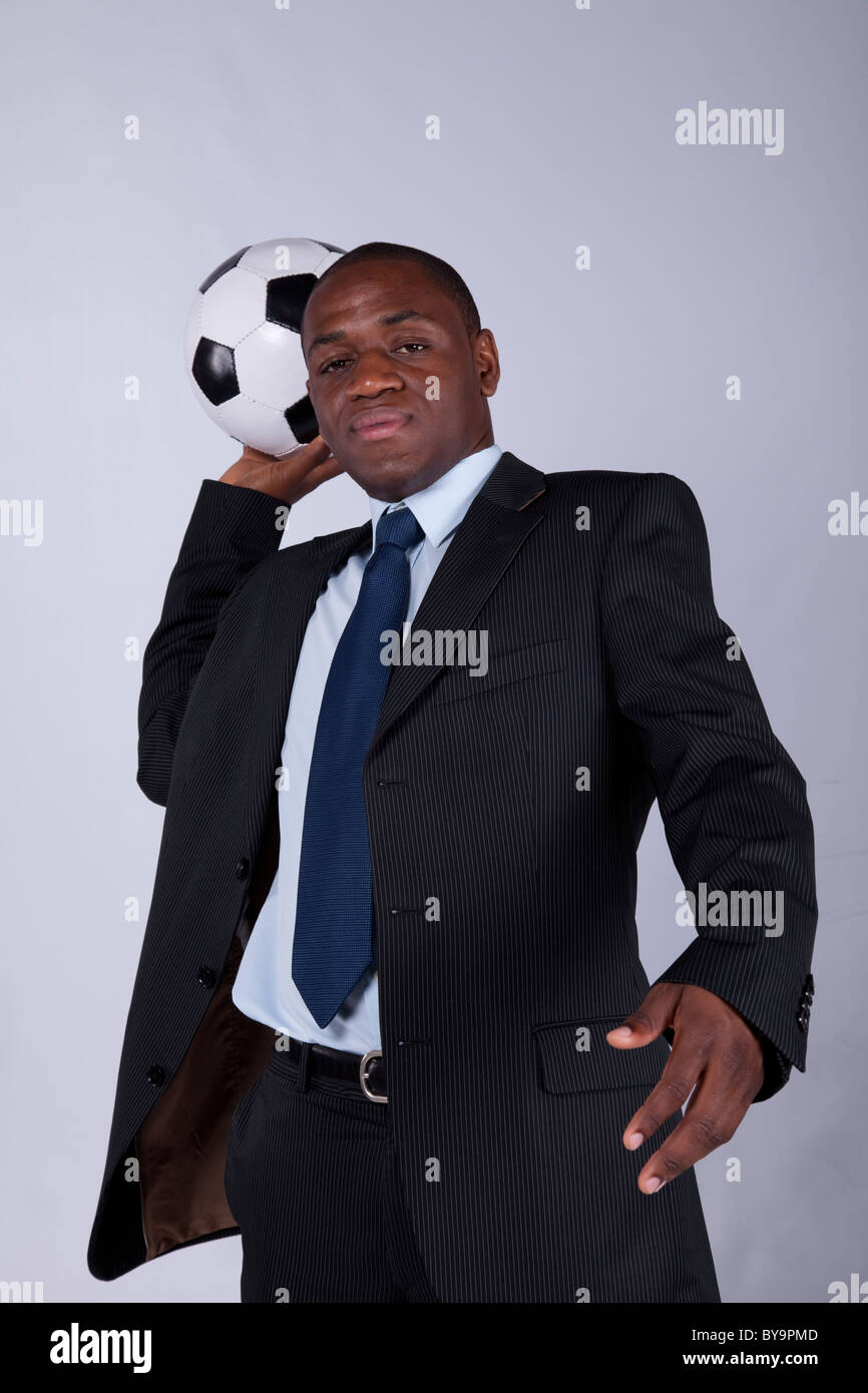 African businessman holding a soccer ball Stock Photo - Alamy
