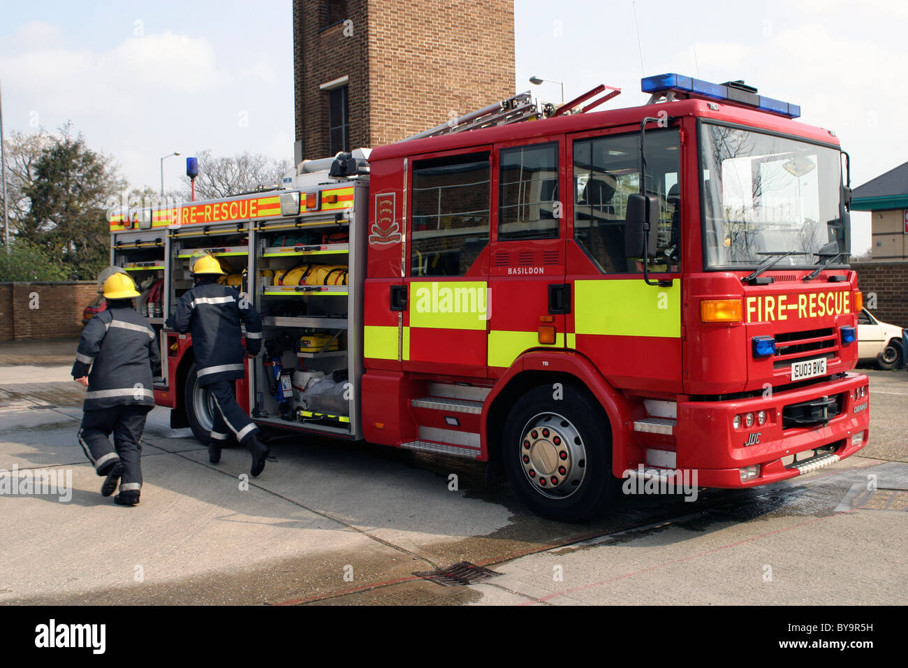 Firemen with fire engine at a fire station Stock Photo - Alamy