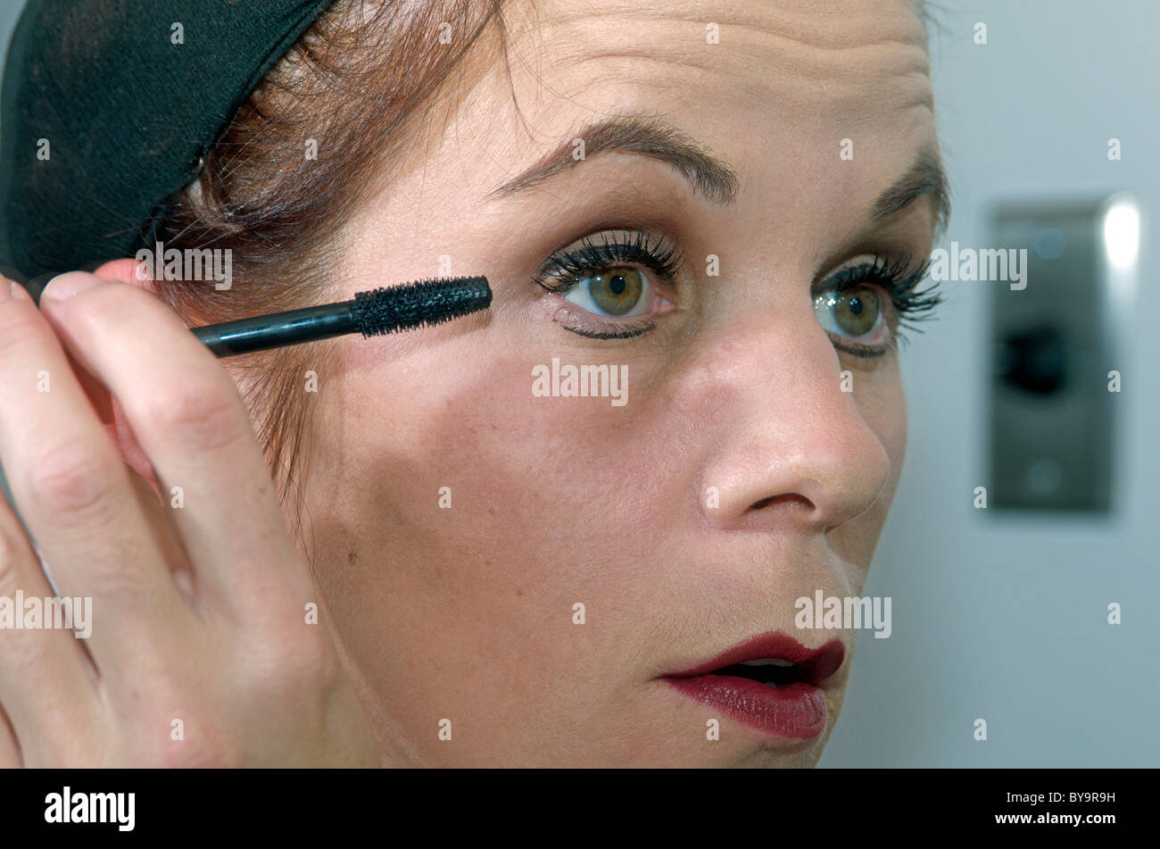 Back stage final make up touches - applying mascara Stock Photo