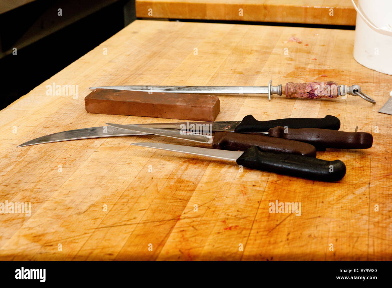 Knives on a butcher's carving table. Stock Photo