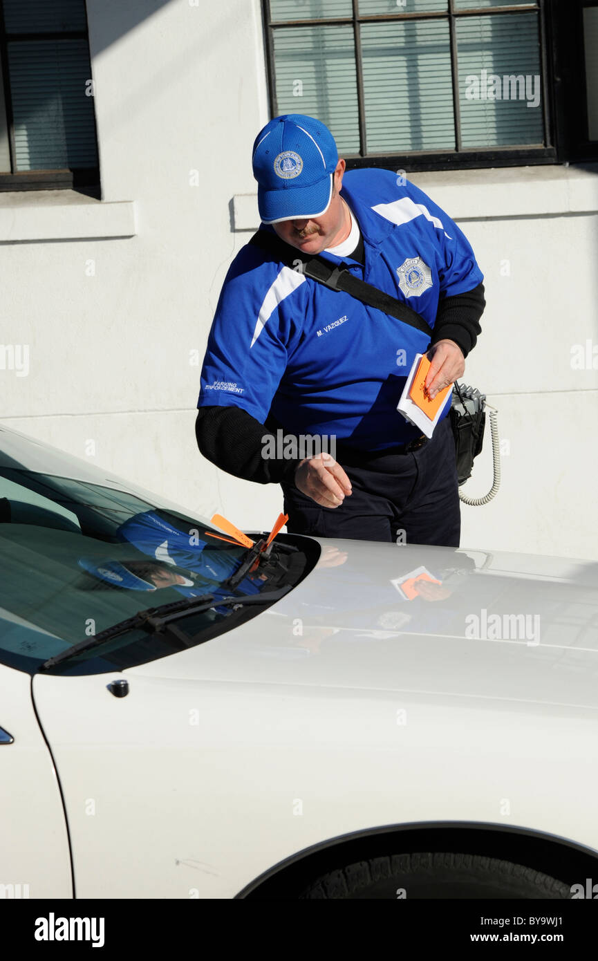 Parking police enforcer writes ticket for expired parking meter Stock Photo Alamy