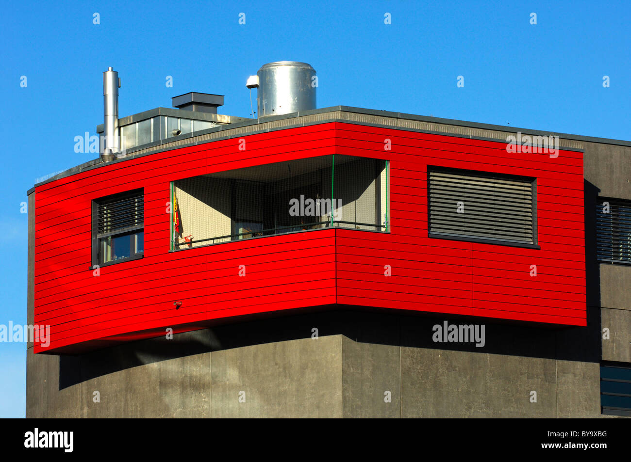 Corner apartment with balcony and red wood paneling, College Sismondi, Geneva, Switzerland Stock Photo