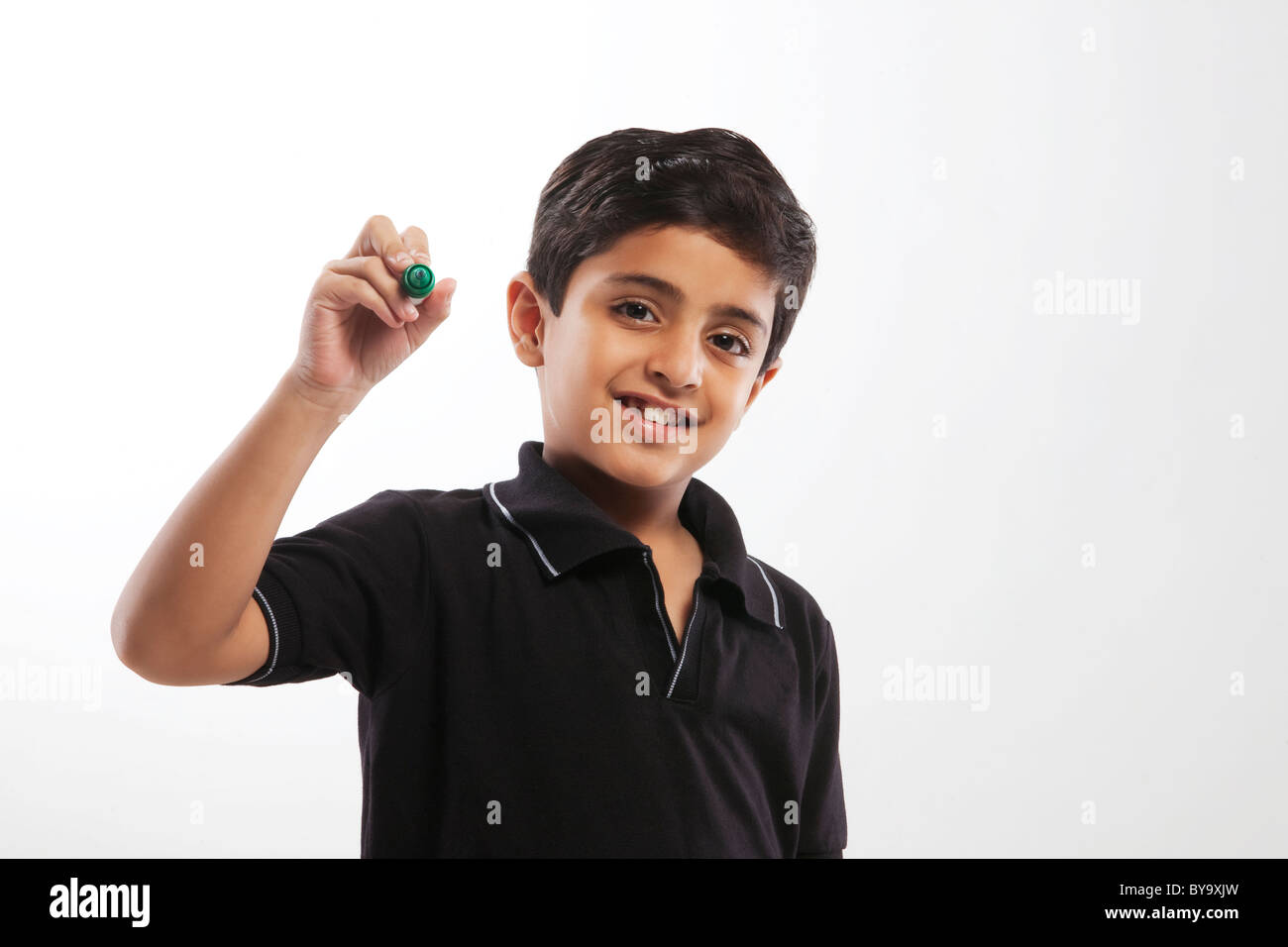 Young boy holding a marker pen Stock Photo
