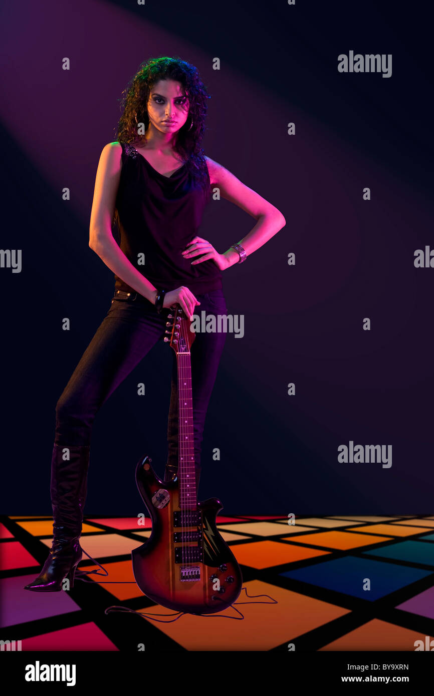Young woman posing with a guitar Stock Photo - Alamy