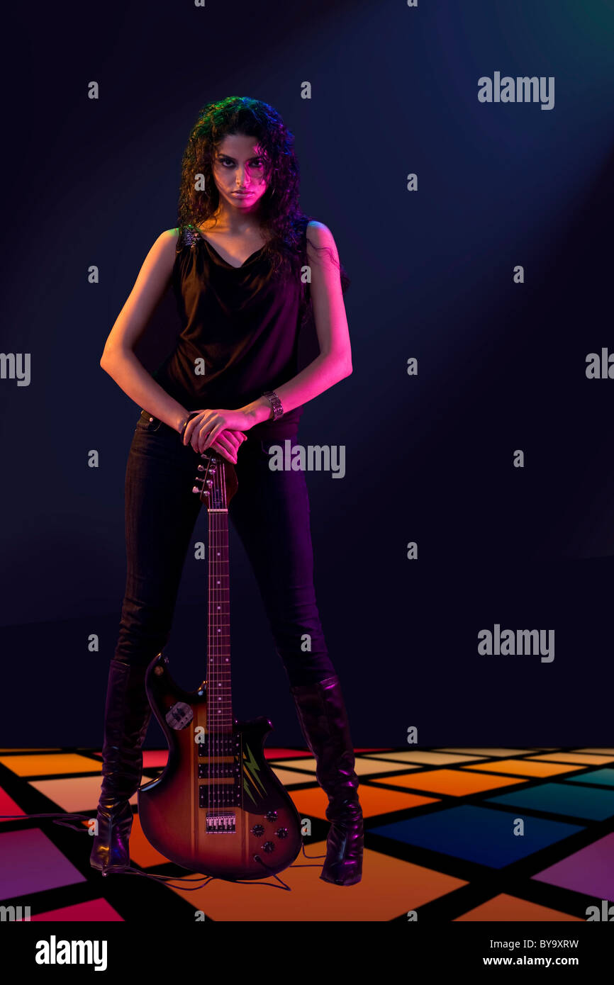 Young woman posing with a guitar Stock Photo - Alamy