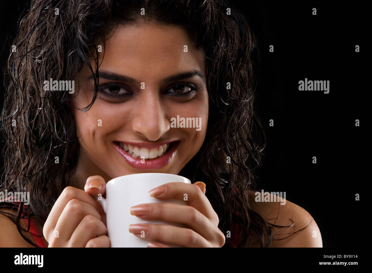 Close-up of a woman holding a mug Stock Photo - Alamy