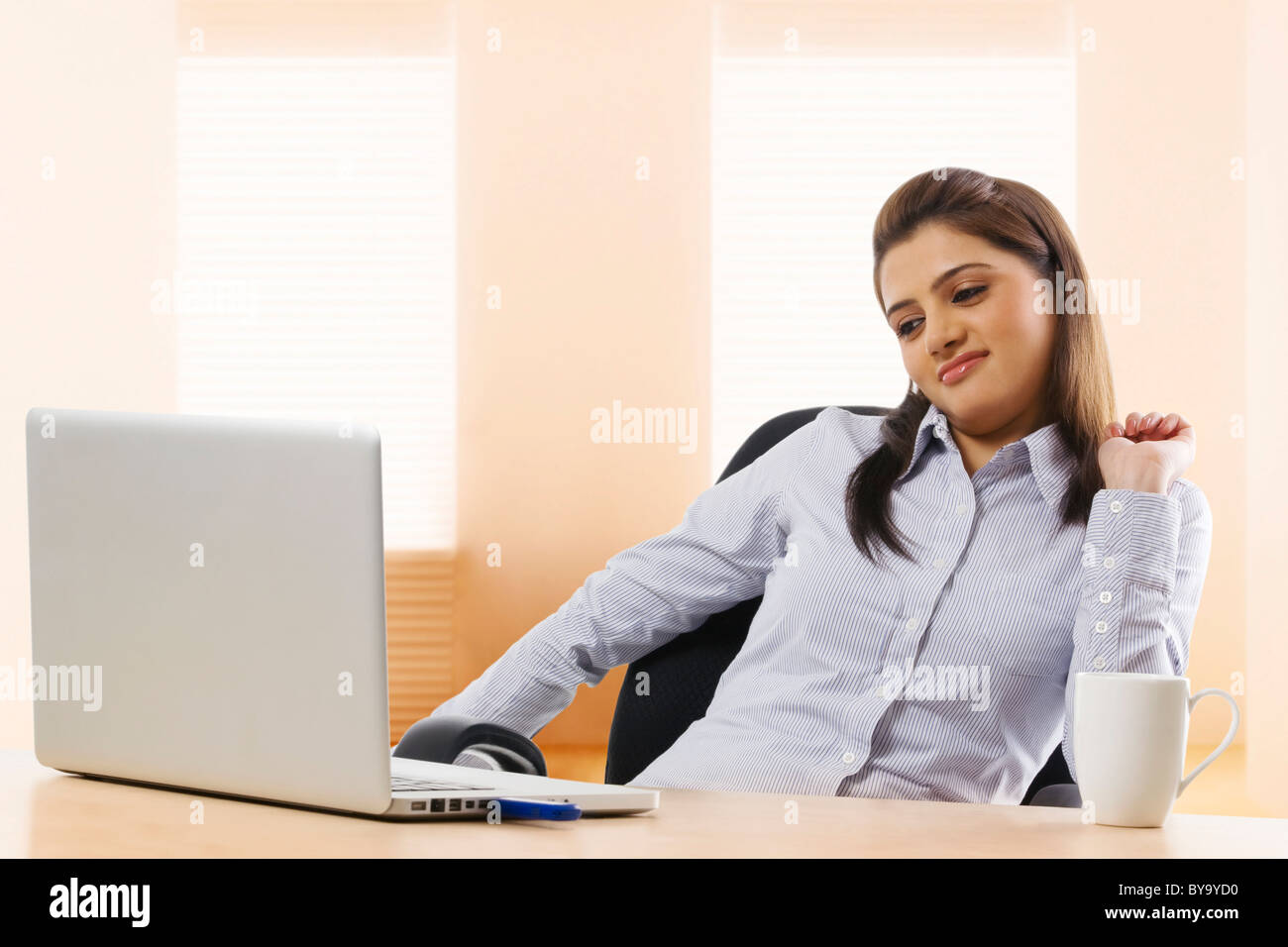 Businesswoman feeling lazy at work Stock Photo