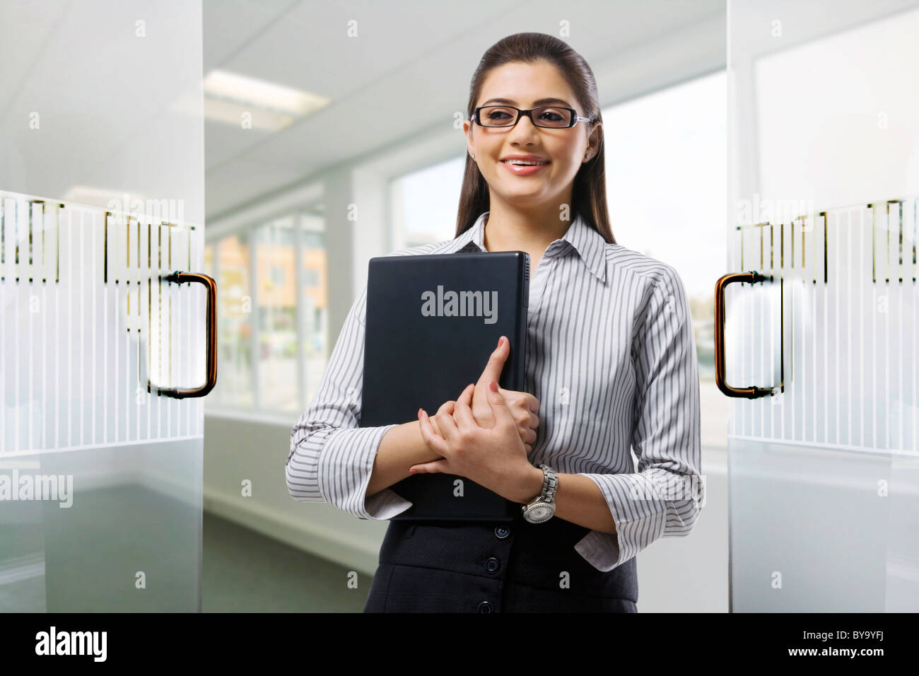 Secretary holding a laptop in the office Stock Photo