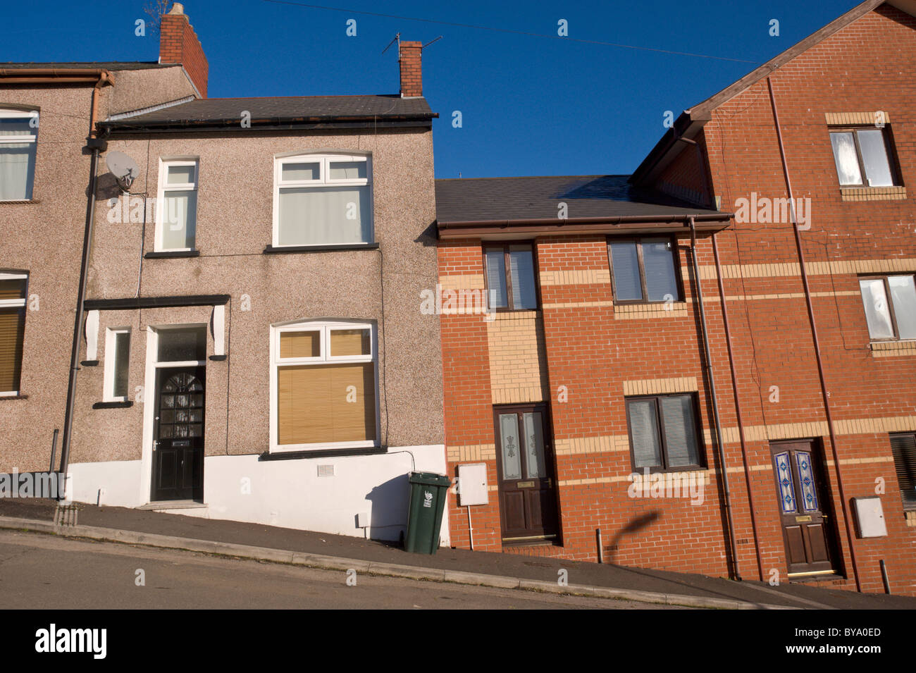Old and new built terraced houses on hill in Newport South Wales UK