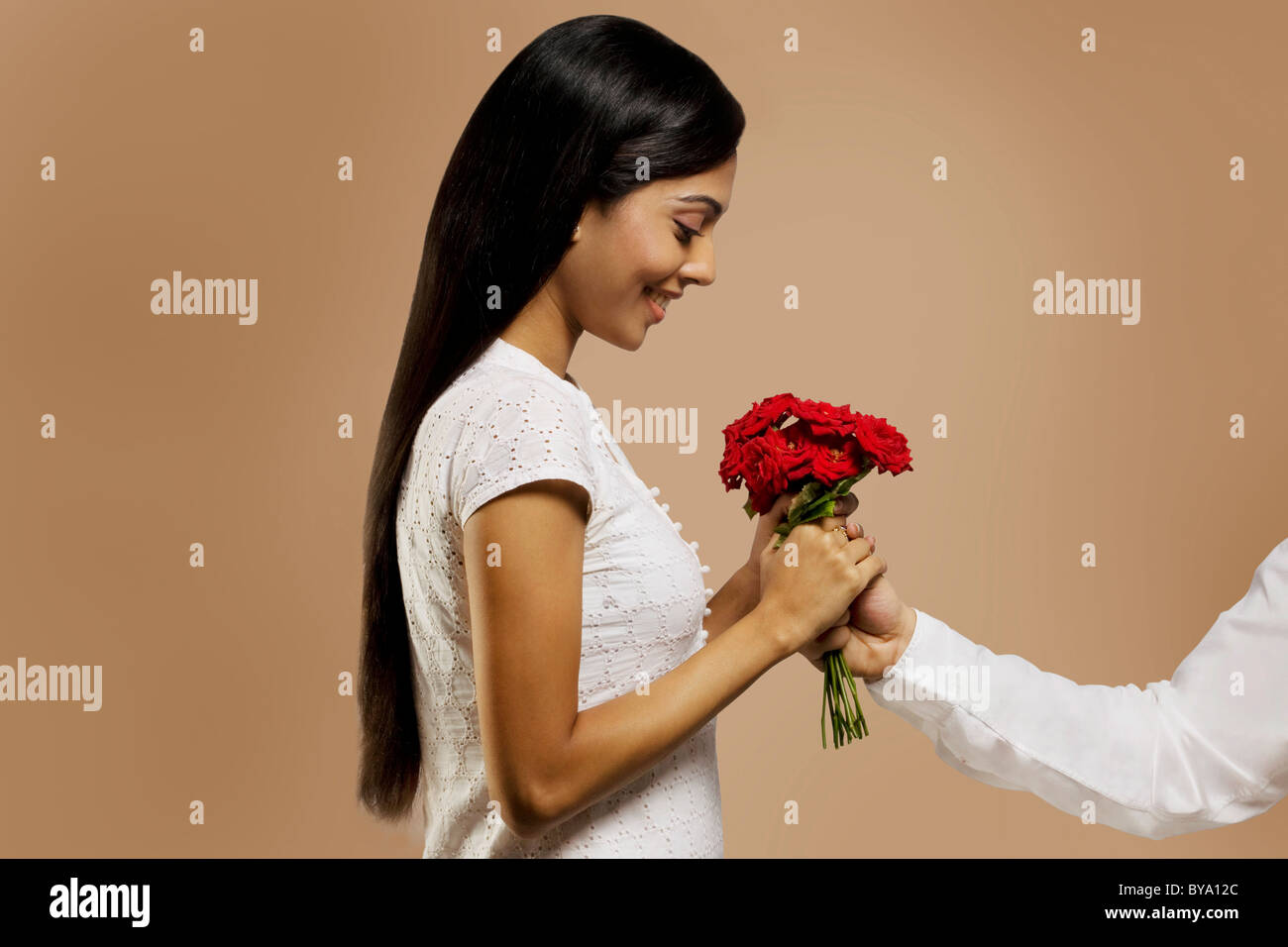 Woman receiving flowers from a man Stock Photo Alamy