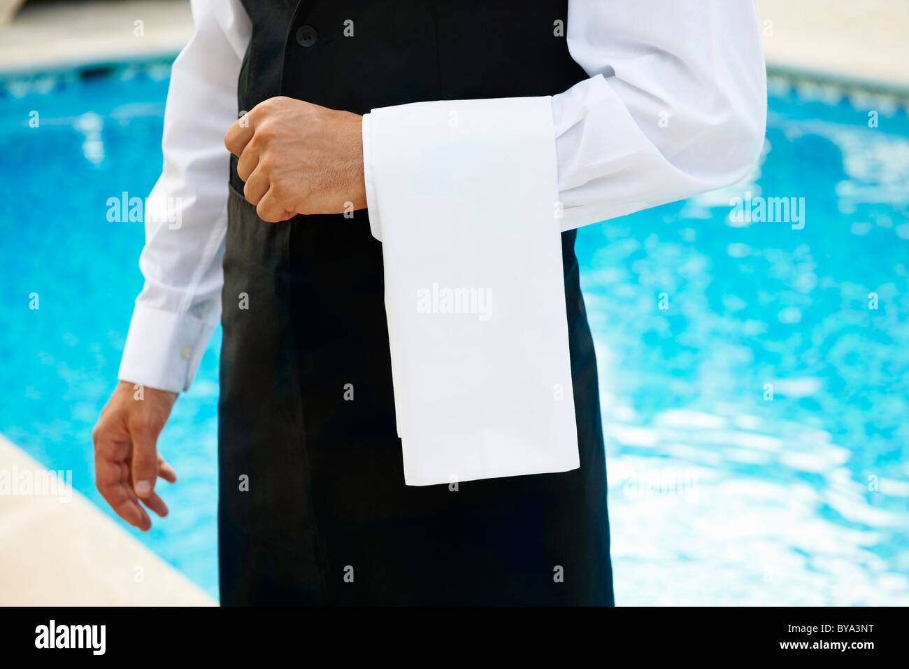 Hotel waiter by pool Stock Photo