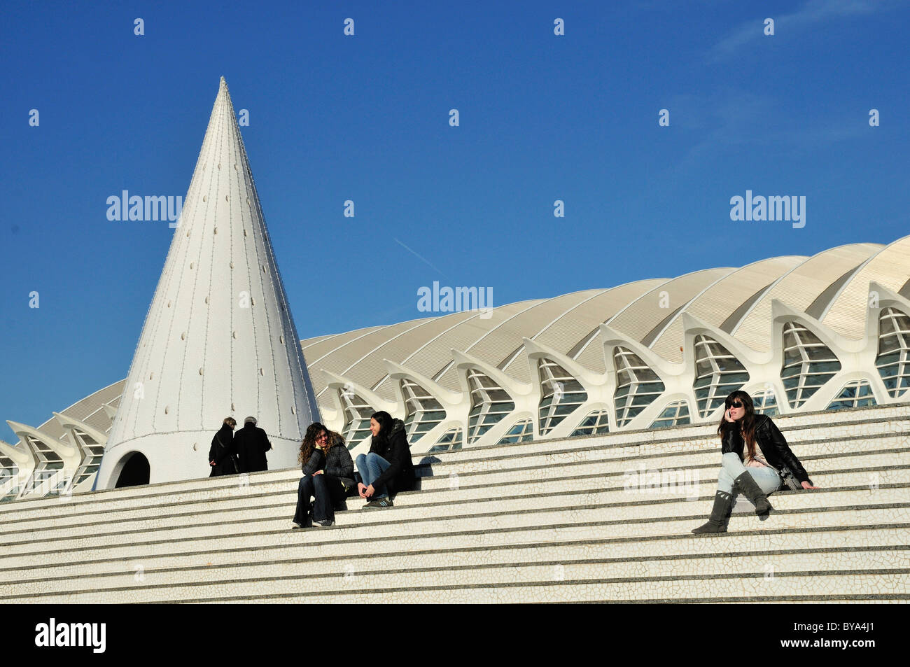 Tourists sitting on the steps of the Ciudad de las Artes y las Ciencias, City of Arts and Sciences, designed by Spanish Stock Photo
