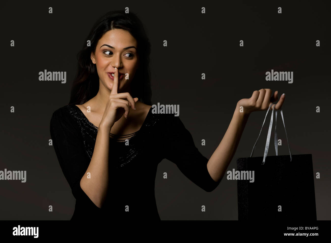 Girl with a gift bag giving a surprise Stock Photo