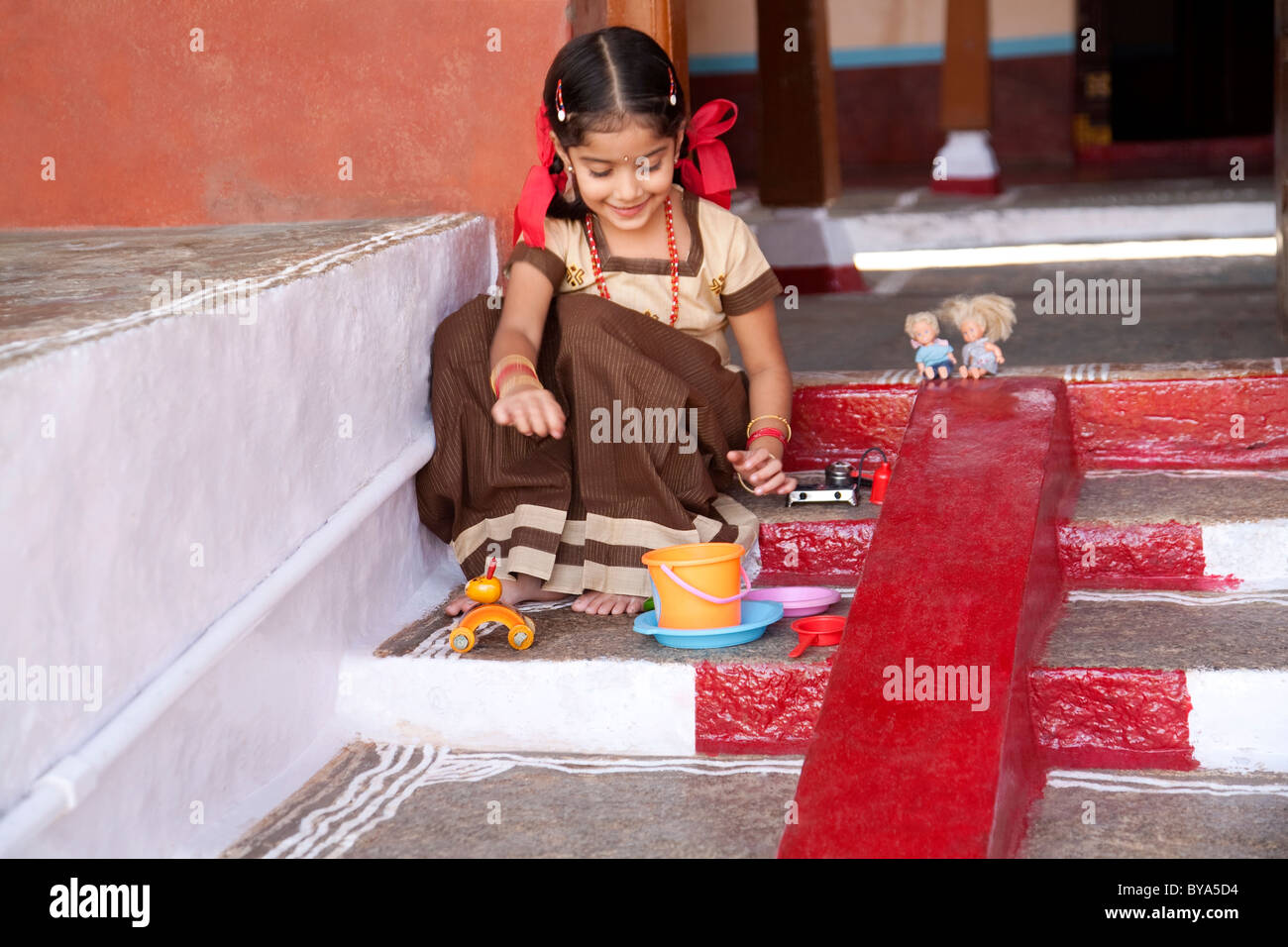 Little girl playing with her toys Stock Photo - Alamy