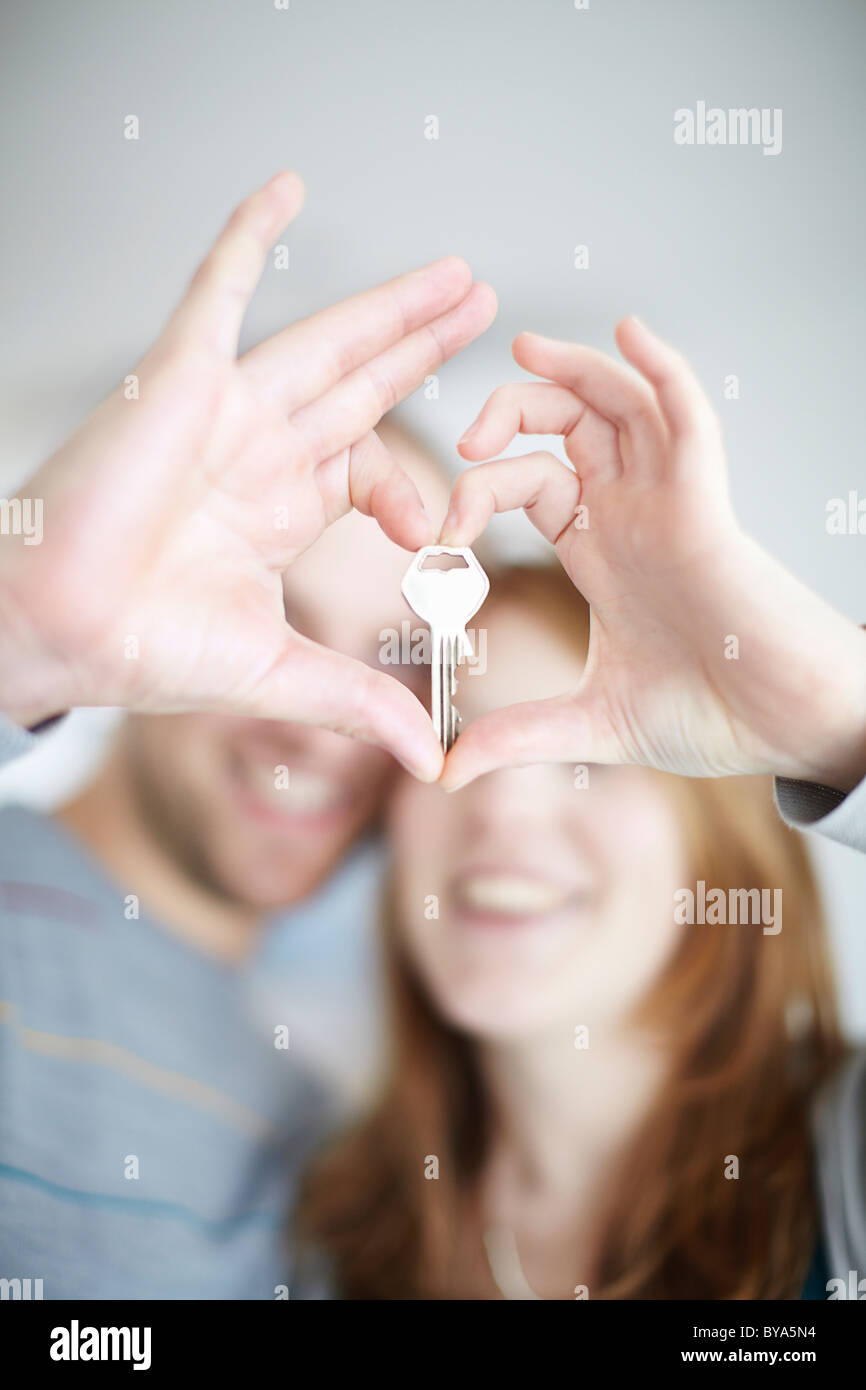 A happy couple holding a key Stock Photo