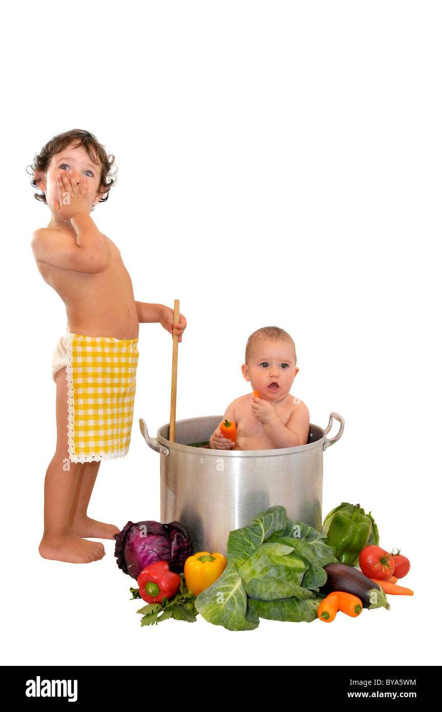 Beautiful young baby in a pan and boy cooking Stock Photo