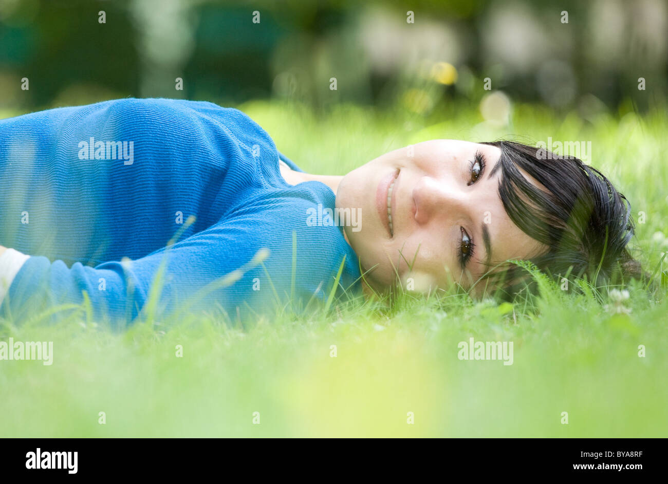 attractive woman relaxing on grass in park Stock Photo - Alamy