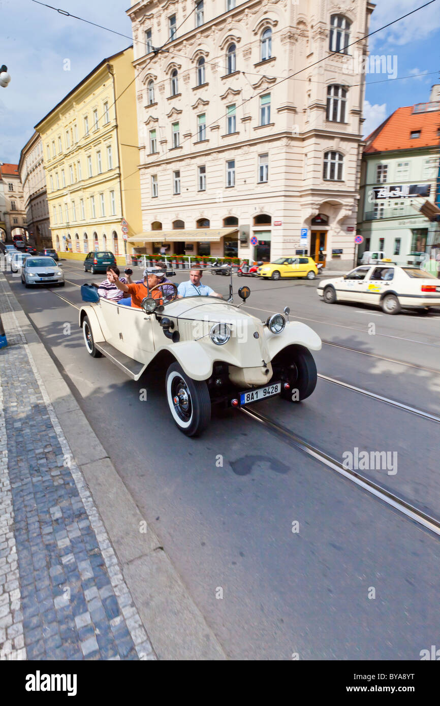 Tourists being driven around in a vintage car in Prague, Czech Republic