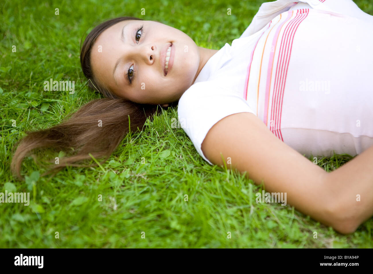 attractive woman relaxing on grass in park Stock Photo - Alamy