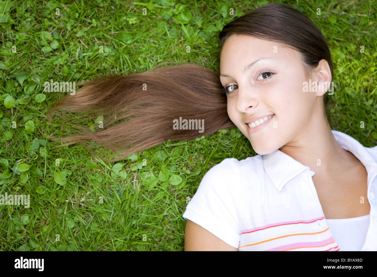 attractive woman relaxing on grass in park Stock Photo - Alamy
