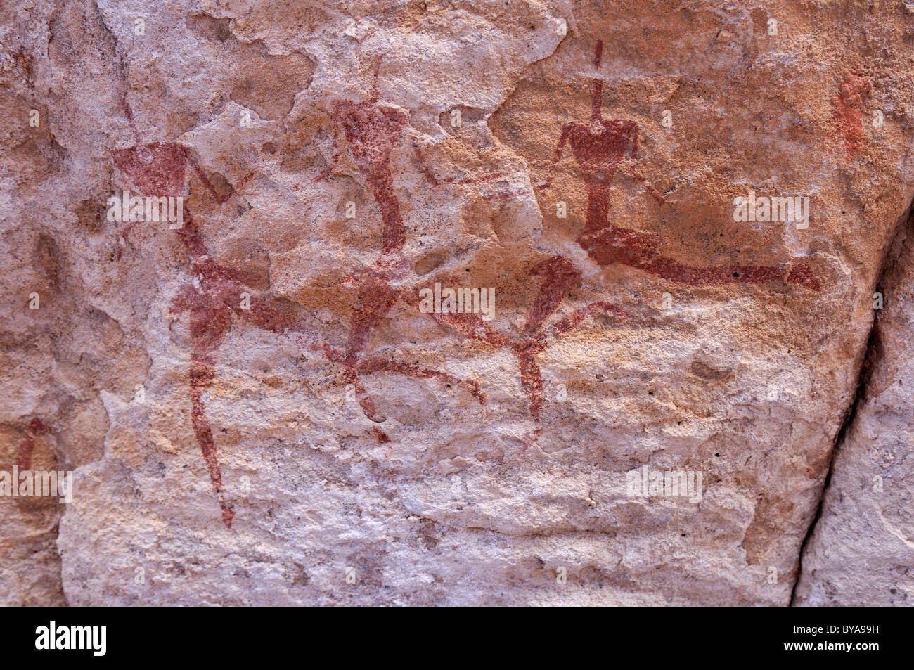Historic painting of running or dancing people, neolithic rock art of Tassili n'Ajjer National Park, Unesco World Heritage Site Stock Photo