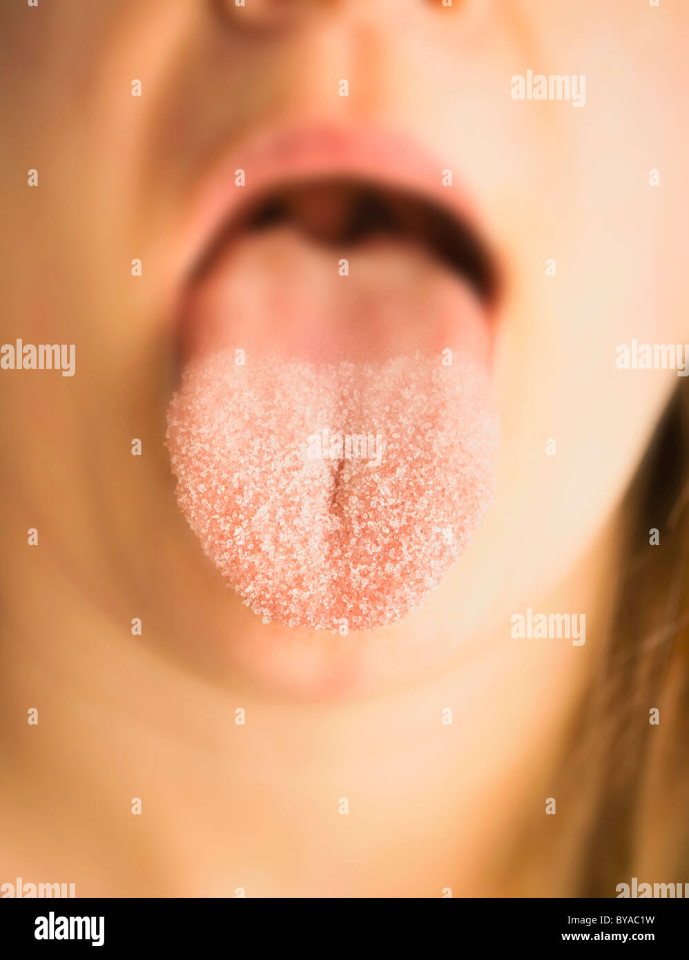 Woman with sugar on her tongue Stock Photo Alamy
