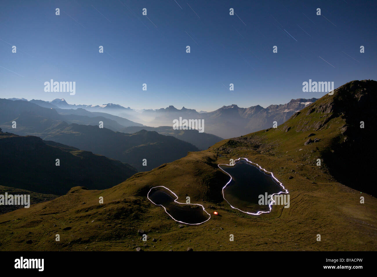 Night view, mountain view at full moon, the contours of the Berglimatt Lakes illuminated by hikers with flashlights Stock Photo