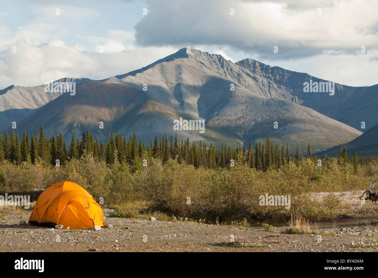 Expedition tent on a gravel bar, Northern Mackenzie Mountains behind