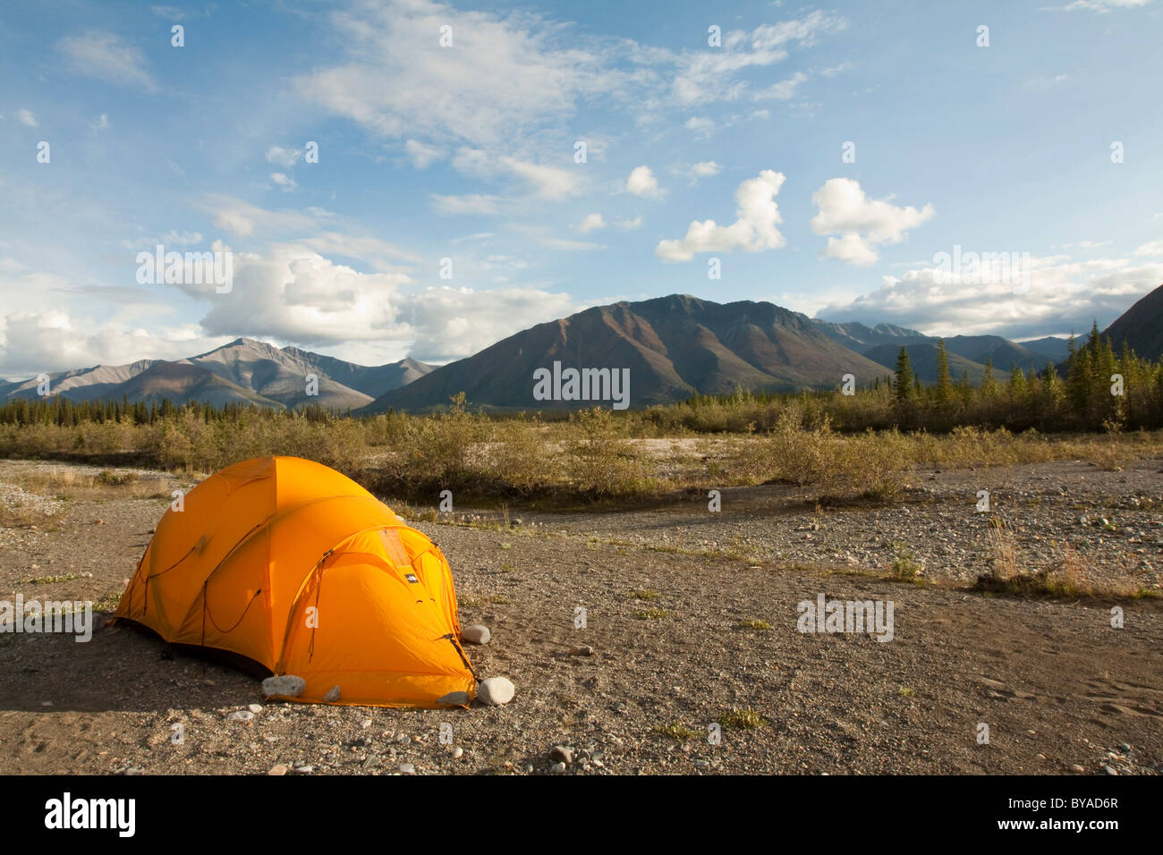 Expedition tent on a gravel bar, Northern Mackenzie Mountains behind