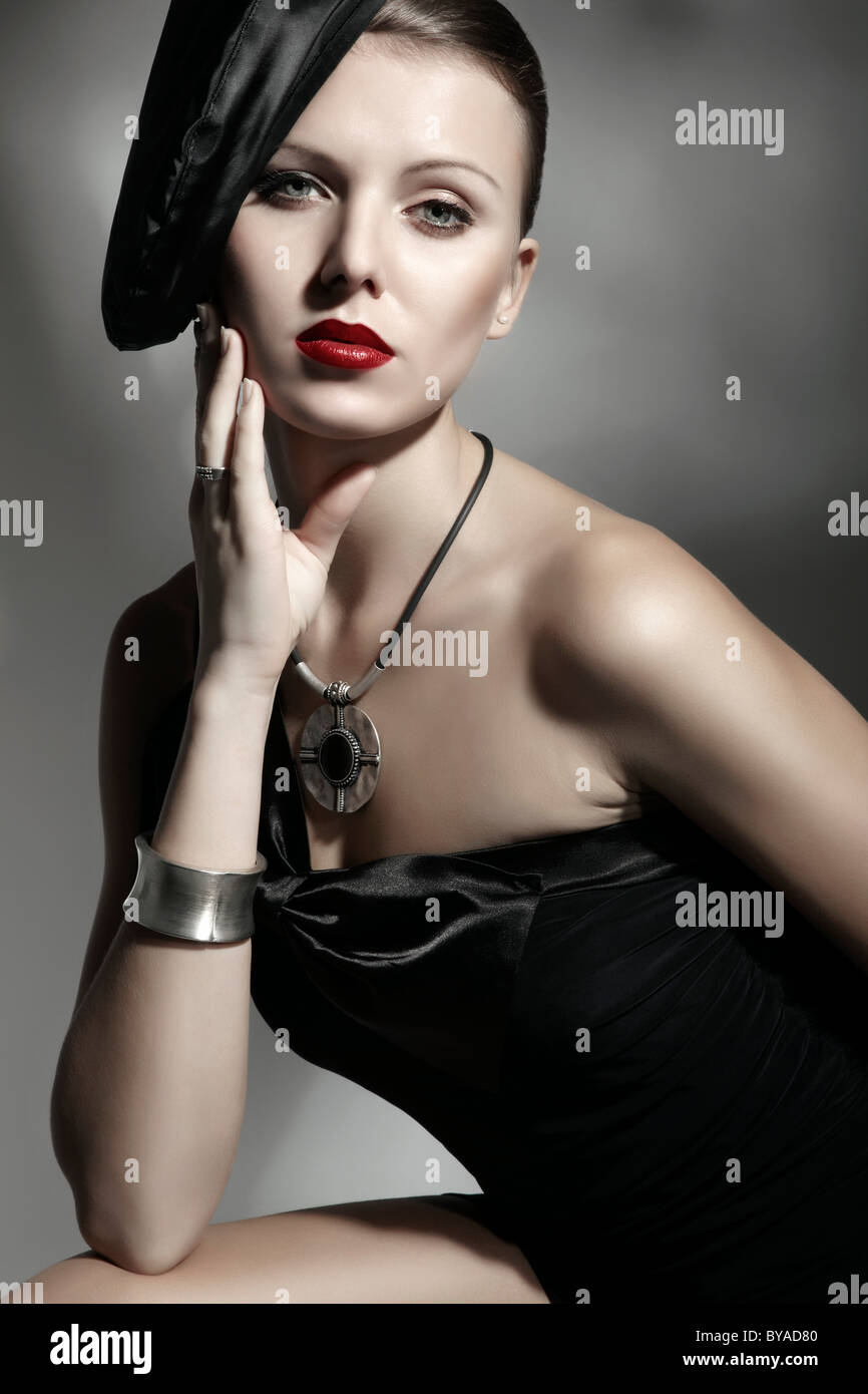 Young woman wearing an elegant hat and a black dress, portrait Stock ...