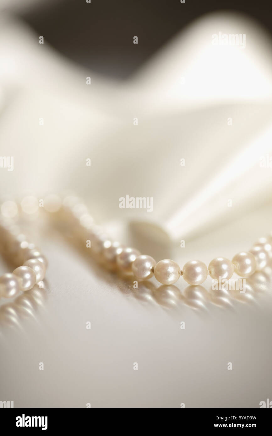 String of pearls and white ribbon, jewellery Stock Photo
