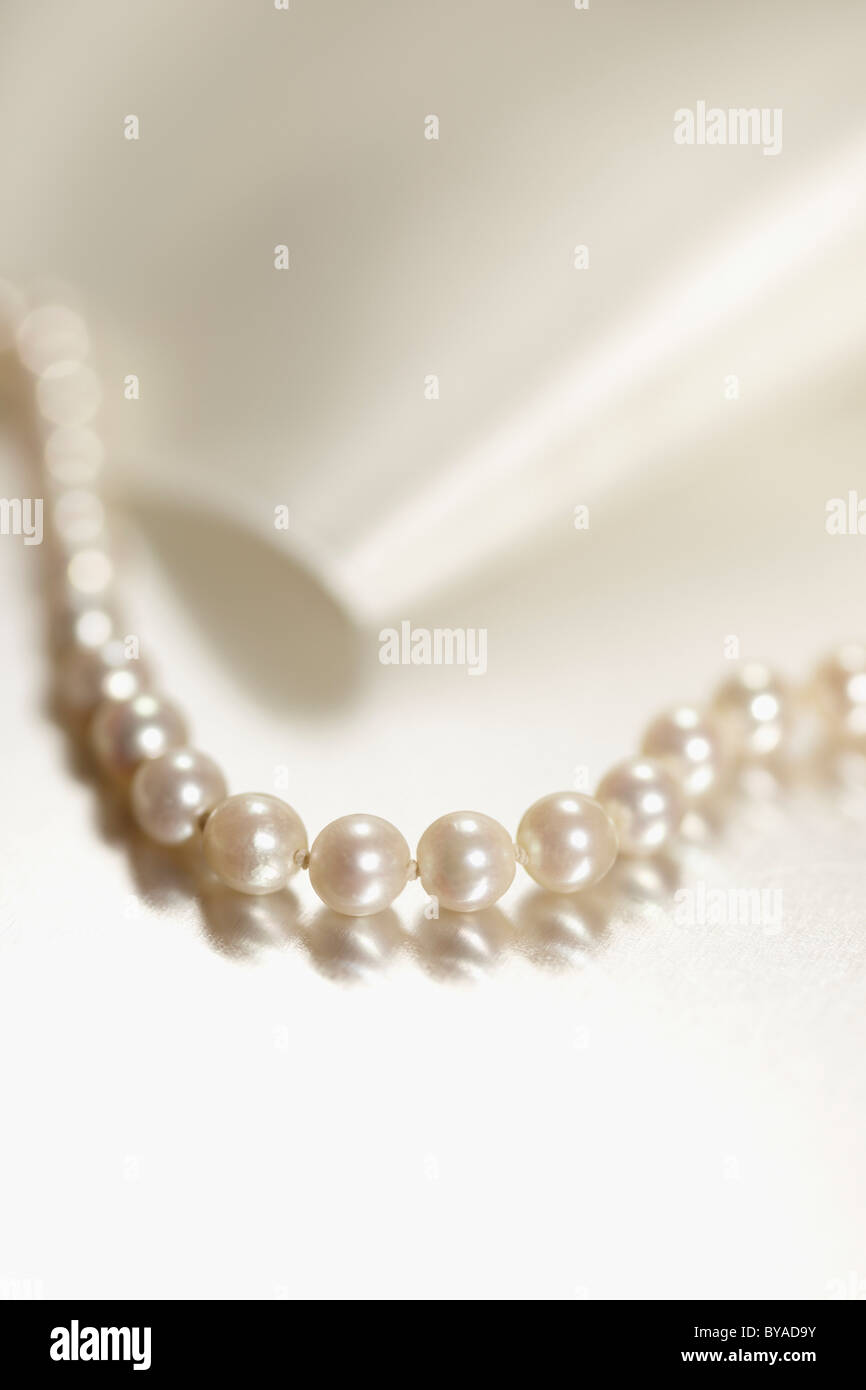 String of pearls and white ribbon, jewellery Stock Photo