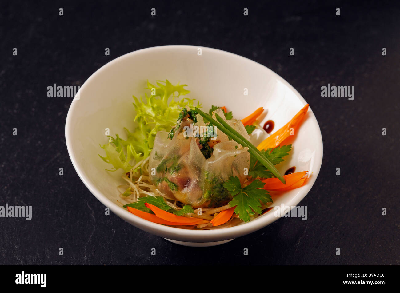 Steamed wontons served with Foie Gras on sprout salad served in a bowl, food, haute cuisine Stock Photo