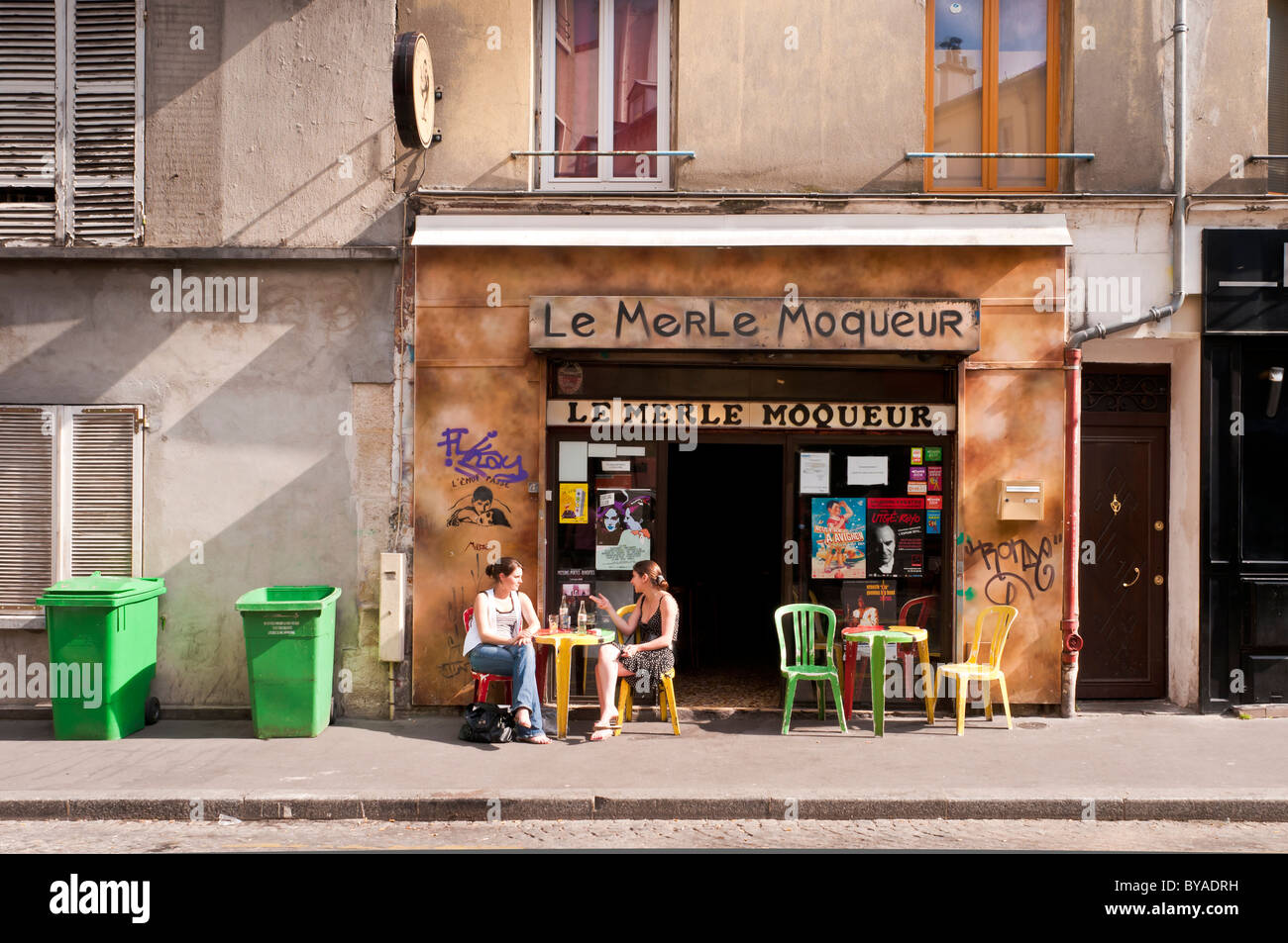 Women enjoying the spring time outside a Café-Bar 'Le Merle Moqueure' on the Neighborhood of the Butte-aux-Cailles, Paris Stock Photo