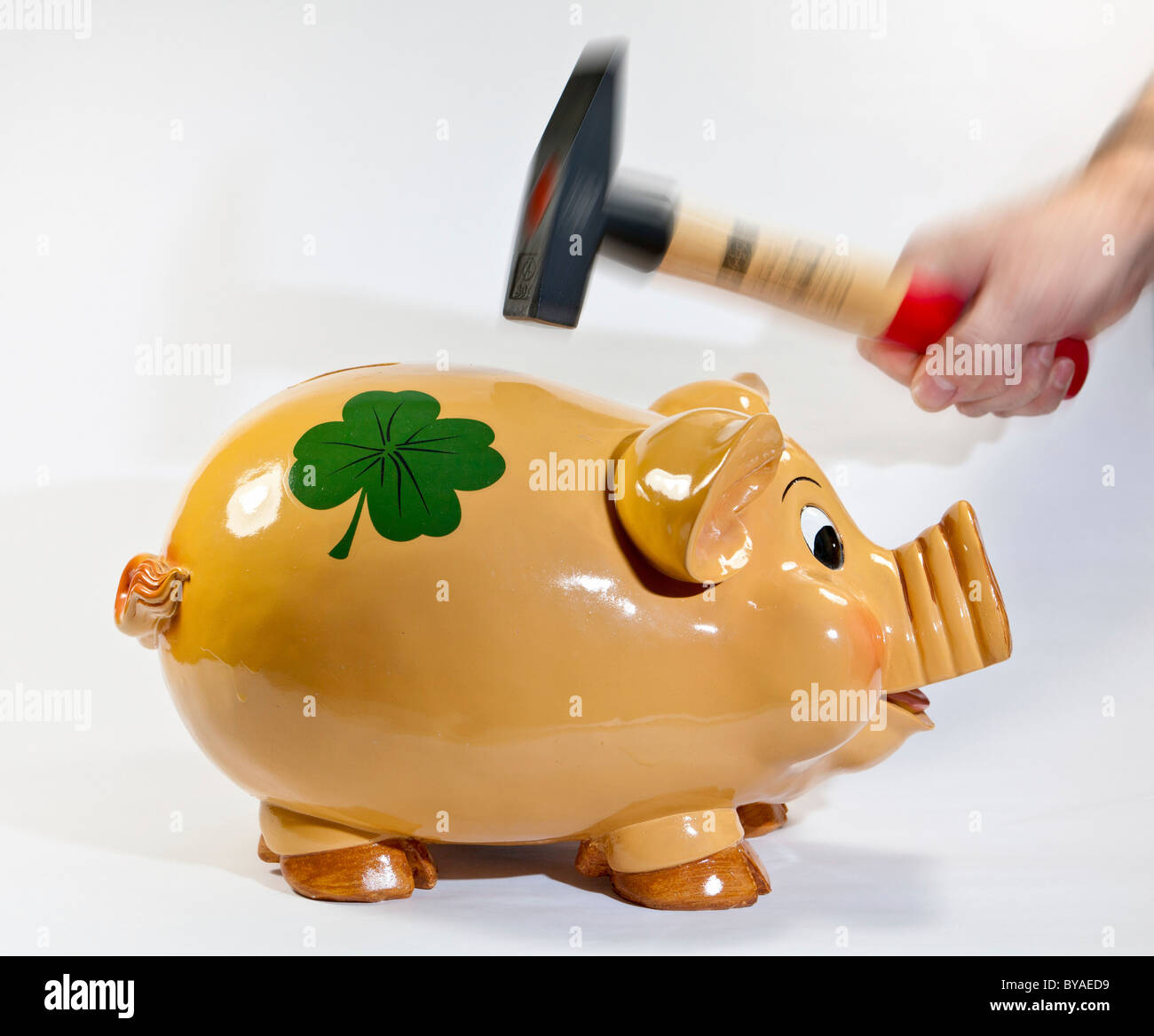 Hammer smashing piggy bank hi-res stock photography and images - Alamy
