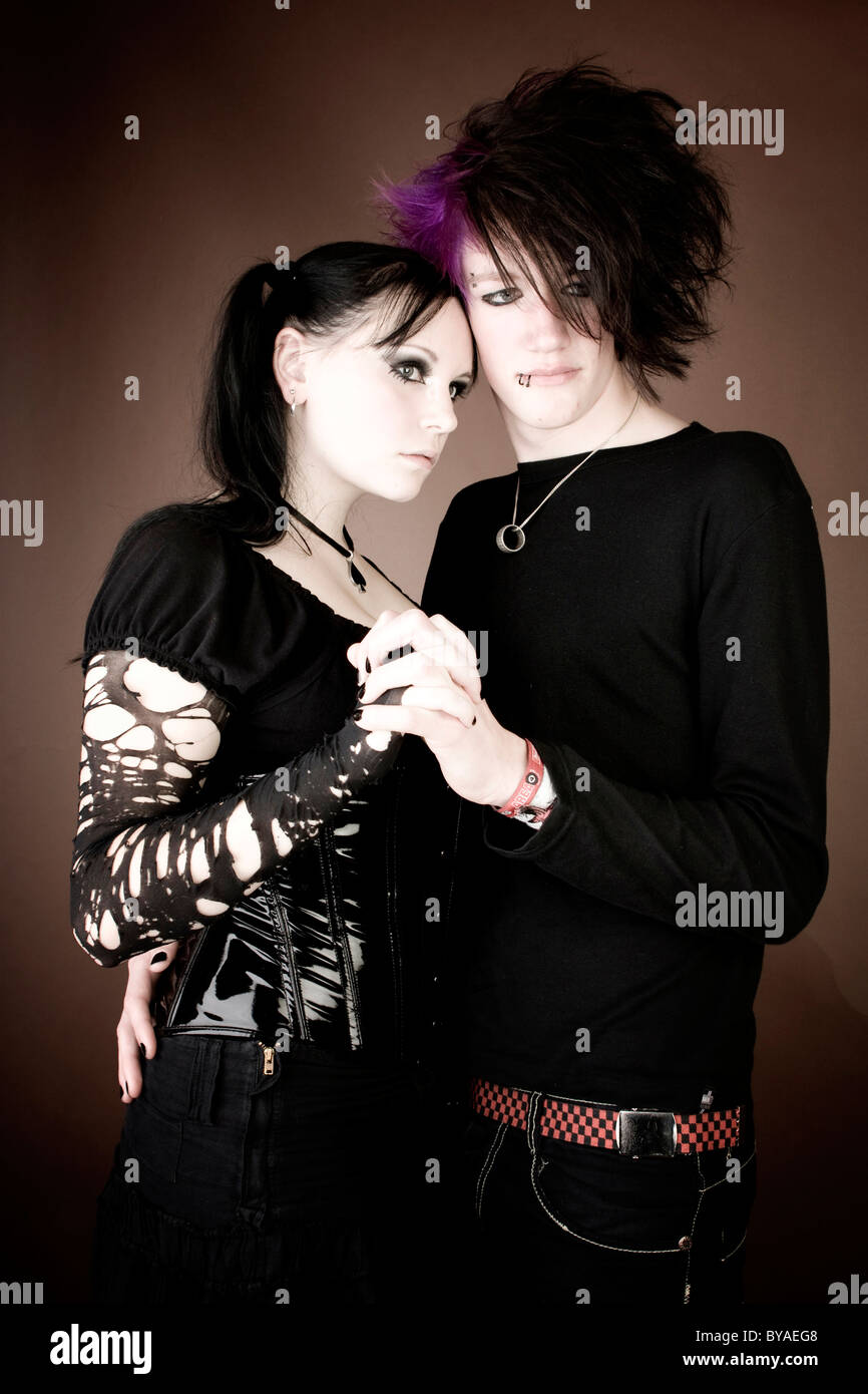 Couple of Goths, emo, looking serious, embracing Stock Photo