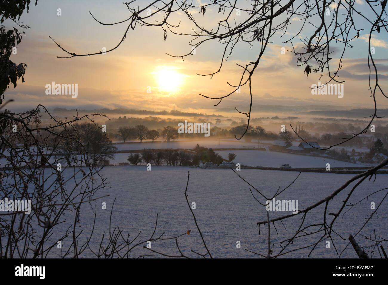 Sunrise over snow covered fields in the county of Torfaen Wales UK Stock Photo