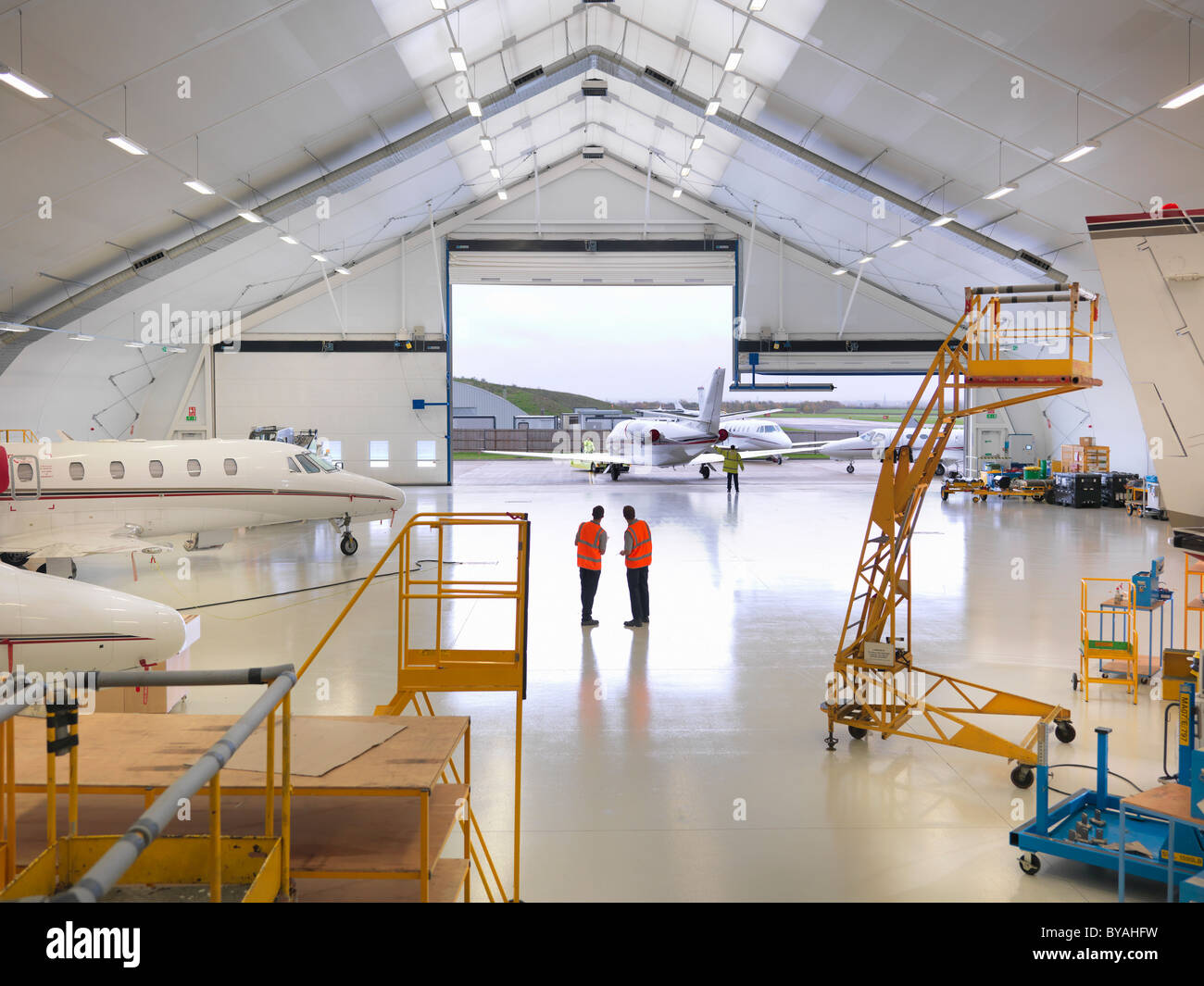 Engineers in jet aircraft hangar Stock Photo